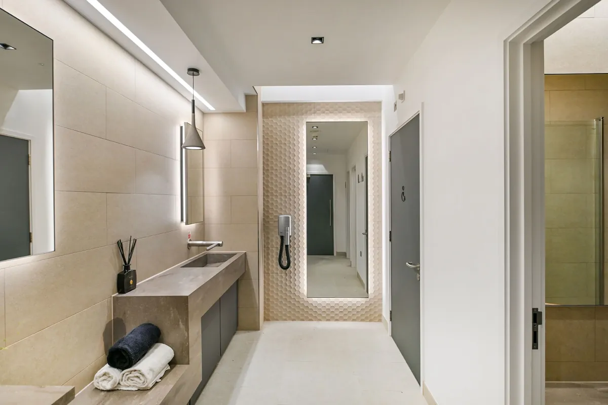 End of trip changing area with a vanity unit and showers